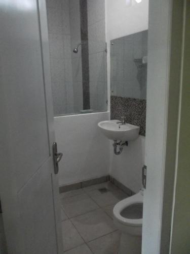 a bathroom with a sink and a toilet at Komodo Boutique Hotel in Labuan Bajo