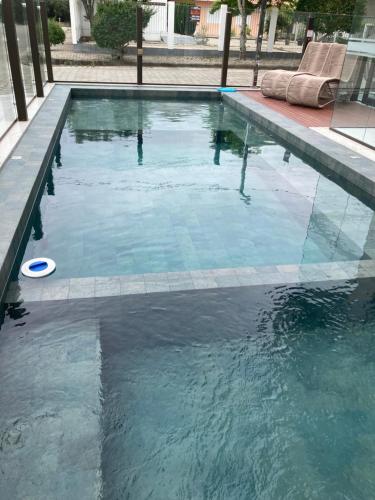 a swimming pool with a frisbee in the water at Conchas das Caravelas in Governador Celso Ramos