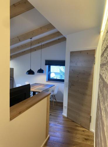 a kitchen with a wooden counter and a dining room at Filder-Appartements in Filderstadt