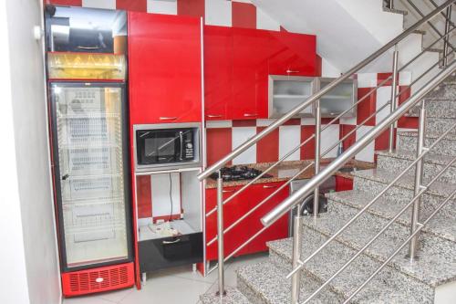 a staircase with red cabinets next to a stair case at Paris Hotel in Praia