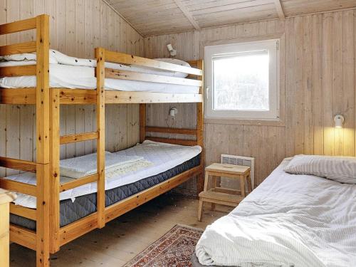 a bedroom with two bunk beds and a window at 7 person holiday home in Fjerritslev-By Traum in Fjerritslev