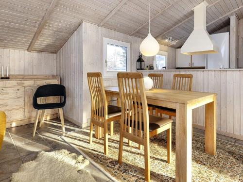 a dining room with a wooden table and chairs at 7 person holiday home in Fjerritslev-By Traum in Fjerritslev