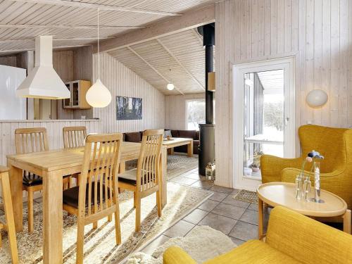 a kitchen and dining room with a wooden table and chairs at 7 person holiday home in Fjerritslev-By Traum in Fjerritslev