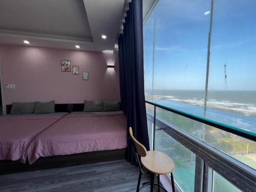 a bedroom with a bed and a view of the ocean at Rio‘s home7 in Vung Tau