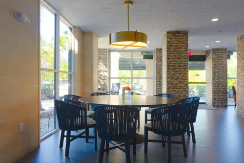 a dining room with a table and chairs at The Palms Inn & Suites Miami, Kendall, FL in Kendall