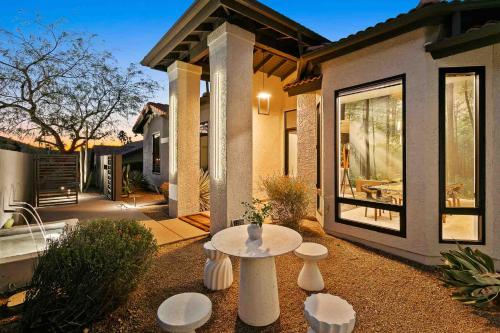 a patio with a table and stools in front of a house at The Concept, A Vacation Retreat in Moon Valley in Phoenix