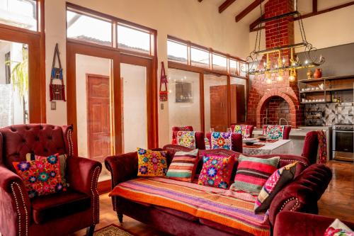 a living room with a couch with colorful pillows at Colonial Home Chachapoyas in Chachapoyas