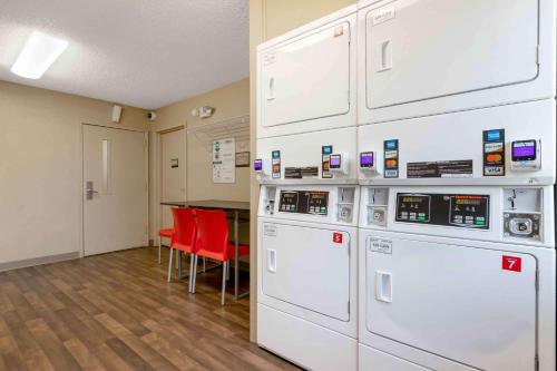 a room with white appliances and red chairs at Extended Stay America Suites - Tulsa - Midtown in Tulsa