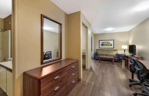 a living room with a dresser and a mirror at Extended Stay America Suites - Cleveland - Great Northern Mall in North Olmsted