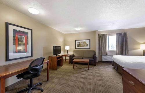 a hotel room with a bed and a desk at Extended Stay America Suites - Cleveland - Great Northern Mall in North Olmsted