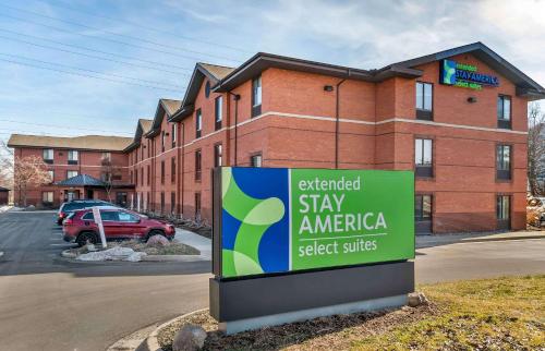 an external stay america sign in front of a brick building at Extended Stay America Select Suites - Detroit - Ann Arbor - University South in Ann Arbor