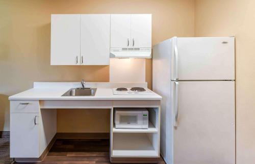a kitchen with a sink and a white refrigerator at Extended Stay America Suites - Hampton - Coliseum in Hampton