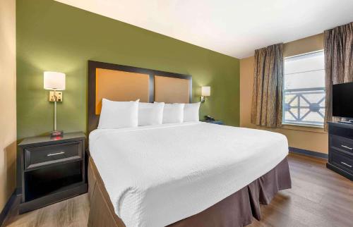 a bedroom with a large bed with a white bedspread at Extended Stay America Suites - Columbus - Polaris in Columbus