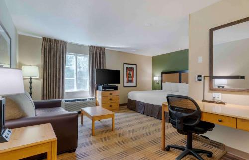 a hotel room with a bed and a desk at Extended Stay America Select Suites - Atlanta - Marietta - Wildwood in Atlanta