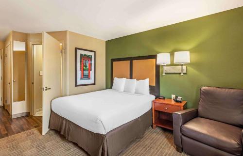 una camera d'albergo con letto e sedia di Extended Stay America Suites - Bakersfield - Chester Lane a Bakersfield