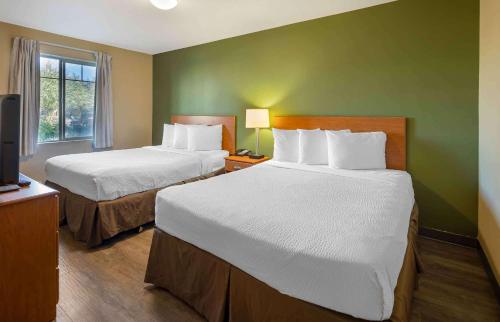 a hotel room with two beds and a television at Extended Stay America Suites - Anchorage - Midtown in Anchorage