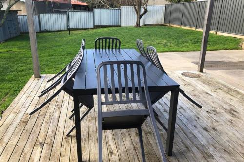 a blue table with four chairs around it at St Albert House in Myrtleford