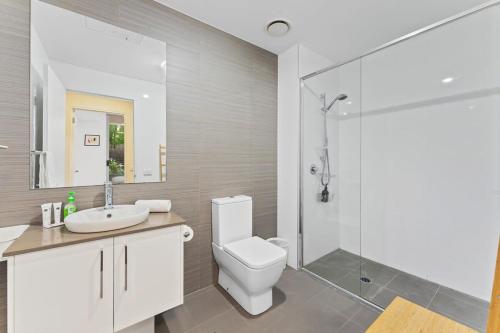 a bathroom with a toilet and a sink and a shower at Tranquil 1-Bed Apartment with Courtyard, Pool, BBQ in Phillip