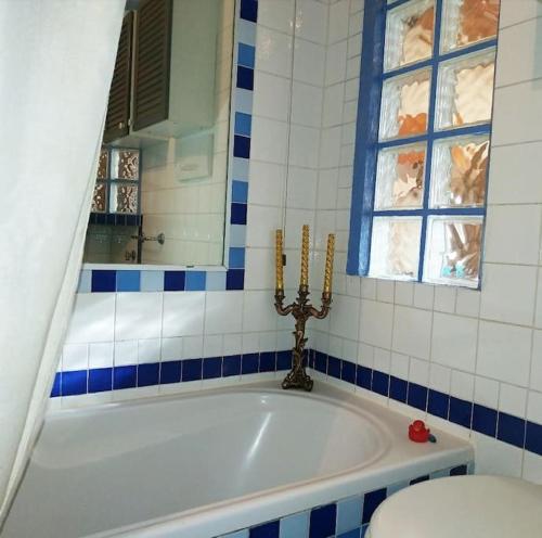 a bathroom with a tub and a window and a toilet at GOLD HOUSE appartamento stazione centrale in Milan