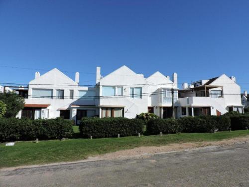 a large white house on the side of a street at Resolana in Punta del Este