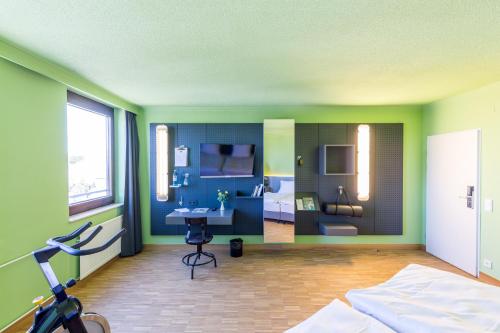 a room with a bedroom with a bed and a desk at mk hotel remscheid in Remscheid