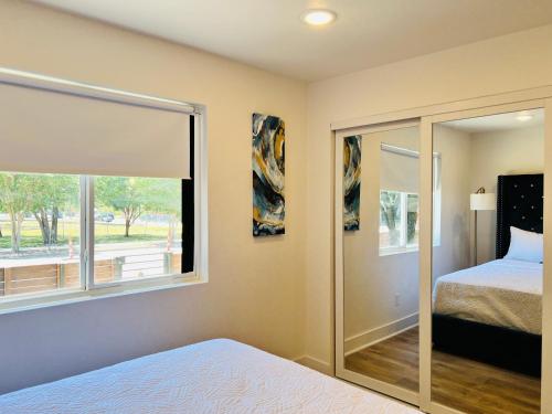 ダラスにあるSerene Hotel Setup with Free Parkingのベッドと大きな窓のある寝室