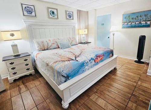 a bedroom with a bed and a night stand at Pensacola Beach Front Emerald Waters in Pensacola Beach