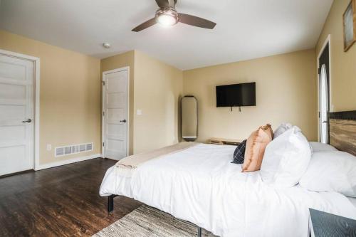 a person laying on a bed in a bedroom at Modern Home of Style & Comfort! in Petoskey