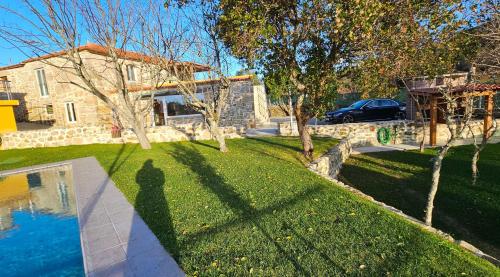a shadow of a person standing in a yard at Casa Gil - AL in Valença