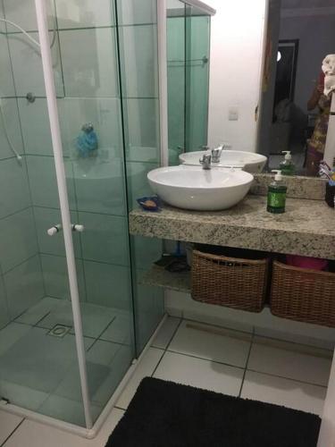 a bathroom with a sink and a glass shower at Lugar pra relaxar...Perto de tudo .. in Búzios