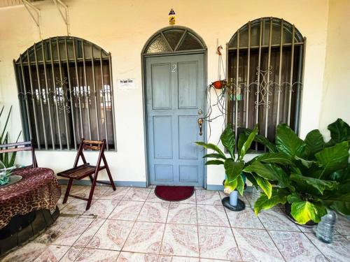 a room with a blue door and some plants at Escape to Pier Sands Casita#2- Close to the Beach. in Puntarenas