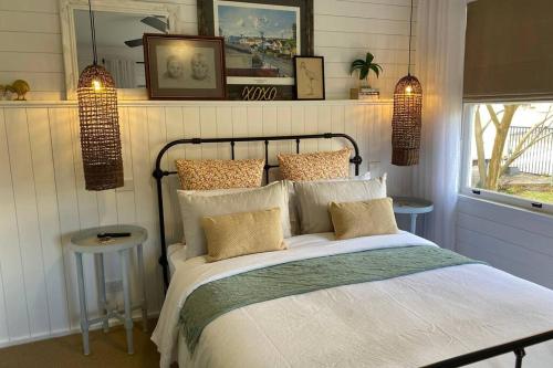 a bedroom with a bed with pillows on it at Stones on Standish TAHI in Myrtleford