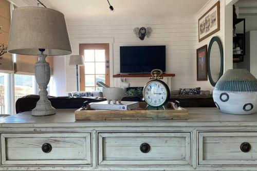 a living room with a dresser with a clock on it at Stones on Standish TAHI in Myrtleford