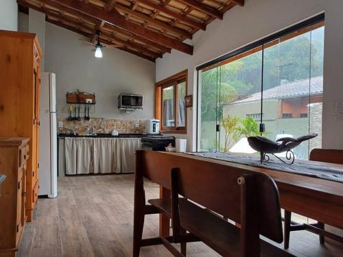 a kitchen with a counter and a large window at Casa Luz do Sol Ubatuba in Ubatuba