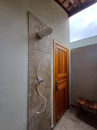 a bathroom with a shower with a shower head on the wall at Casa Luz do Sol Ubatuba in Ubatuba