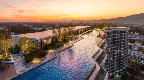 - une vue aérienne sur un bâtiment avec piscine dans l'établissement Astra Sky River- Chiang Mai 1, à Chiang Mai