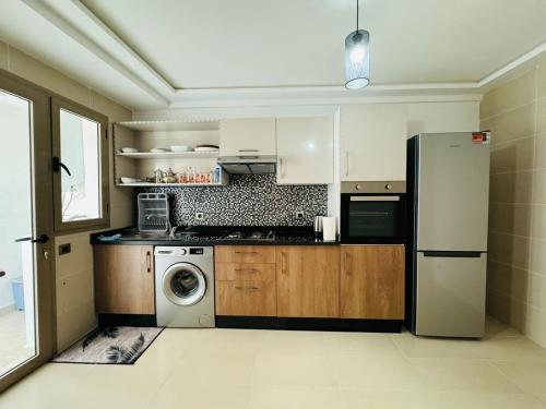 uma cozinha com um frigorífico e uma máquina de lavar roupa em Paradise Prestigia em Fez