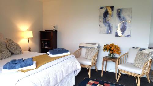 a bedroom with a bed with blue towels on it at seaview in Tairua