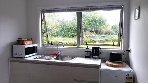 a kitchen with a sink and a window at seaview in Tairua