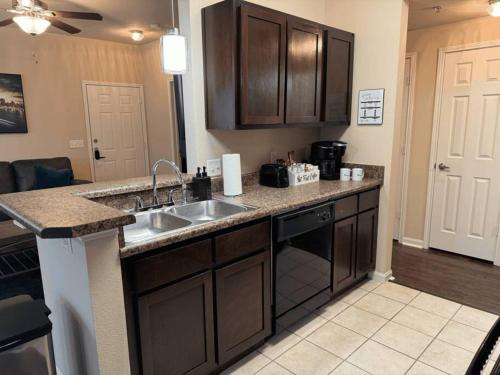 a kitchen with a sink and a counter top at Magnolia Serenity: 2BD/1BA w/ Gym, Pool, BBQ Grill in Tupelo