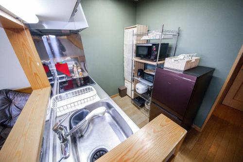 a kitchen with a washing machine in a room at Learch Asahikawa in Asahikawa
