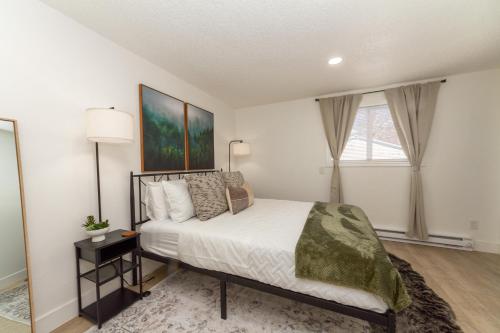 a bedroom with a bed and a large window at Quaint 1 BD 1 BTH Guest Home Minutes from Gonzaga in Spokane