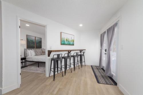 a white living room with a bar with stools at Quaint 1 BD 1 BTH Guest Home Minutes from Gonzaga in Spokane