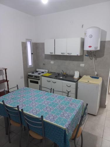 a kitchen with a table with chairs and a sink at Departamento La Lita in Chilecito