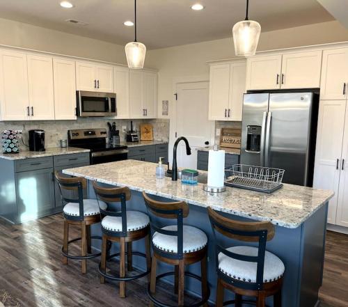 a kitchen with a large island with bar stools at Fun House at SML Adventure filled Lake Retreat in Huddleston