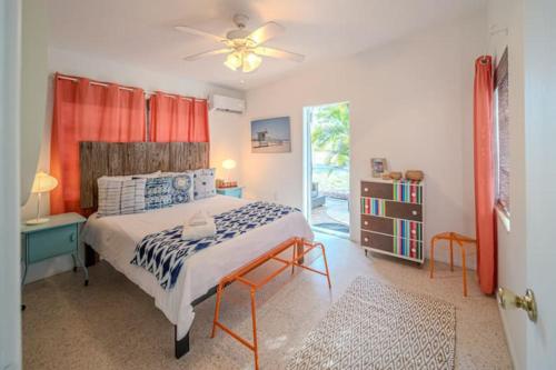 a bedroom with a bed and a ceiling fan at Beachside Bliss 1 miles to the beach with heated pool in Sarasota