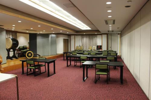 a conference room with tables and chairs and a cannon at Fuji Yamanakako Hotel in Yamanakako