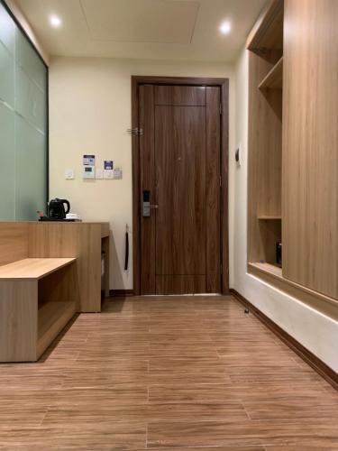 an office with a wooden door and a wooden floor at Azumaya Hotel Hai Phong in Hai Phong