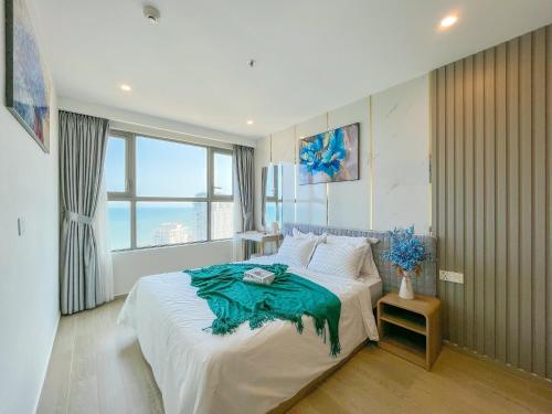 a bedroom with a large white bed and a window at The Sóng Luxury Apartment Vung Tau - Tuấn Hoà Homestay in Vung Tau