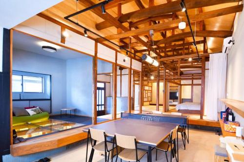 a room with a table and chairs and a bed at GuestHouseYULLAT in Horiechō
